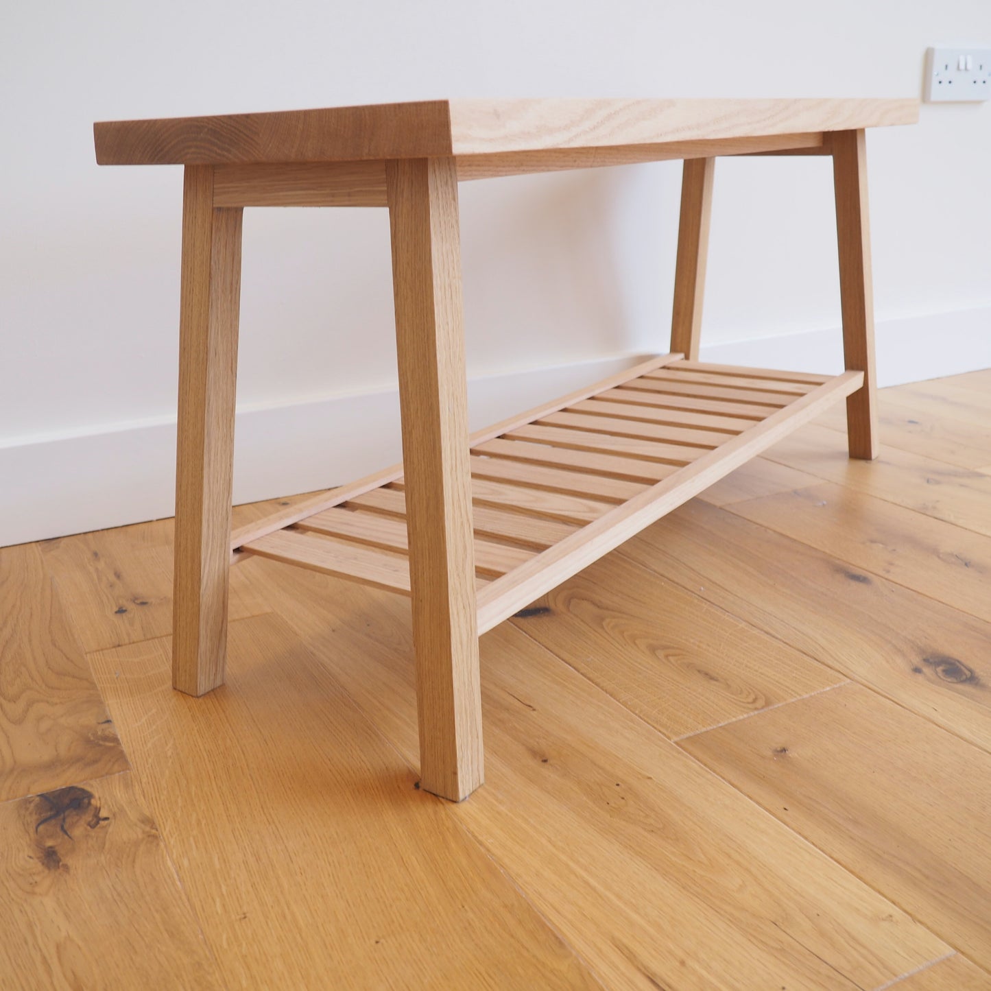 Solid Oak bench with shoe storage.